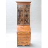 An Edwardian mahogany bureau bookcase, the upper section with moulded and dentil cornice, the