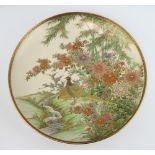 An early 20th Century Satsuma dish decorated with exotic birds beneath flowering trees 31cm