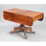 A William IV mahogany pedestal Pembroke table fitted a drawer, raised on a turned column and triform