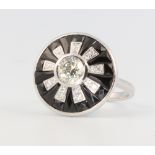 An 18ct white gold Art Deco style diamond and onyx target ring, the centre stone approx. 0.7ct, size