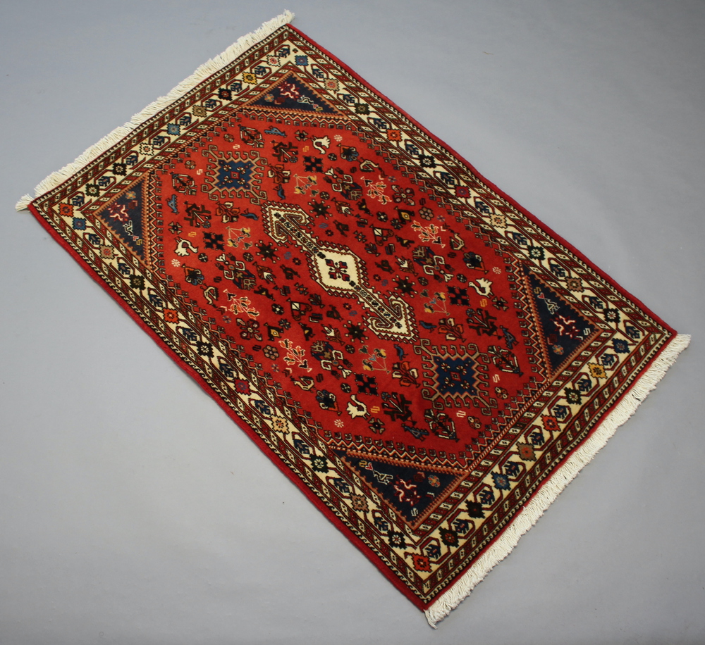 A brown and blue ground North West Persian rug with central medallion 167cm x 101cm