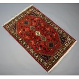 A brown and blue ground North West Persian rug with central medallion 167cm x 101cm