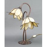 A Libertys style bronze twin light table lamp in the form of 2 flower heads, raised on a lily shaped