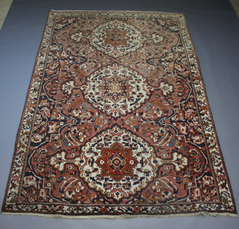 A Boldaji pink, white and blue ground Persian carpet with 3 medallions to the centre 306cm x 210cm
