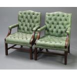 A handsome pair of Gainsborough style open arm library chairs upholstered in faded green buttoned