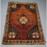 A brown and black ground rug with central medallion 184cm x 126cm