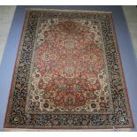 A brown and cream ground Persian carpet with central medallion within multi row border 361cm x 275cm
