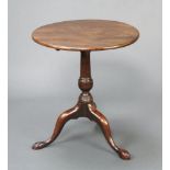 A circular Georgian mahogany snap top wine table raised on a pillar and tripod base 65cm h x 57cm
