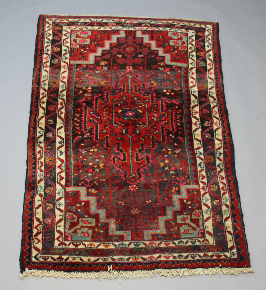 A North West Persian red and white ground rug with central medallion within multi row border 160cm x