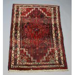 A North West Persian red and white ground rug with central medallion within multi row border 160cm x