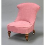 A Victorian nursing chair with pink loose cover, on turned supports 73cm h x 53cm w x 49cm d (seat