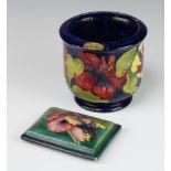 A Walter Moorcroft blue ground jardiniere decorated with hibiscus, signed monogram and impressed
