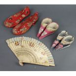 Three pairs of Chinese silk embroidered slippers and a fan