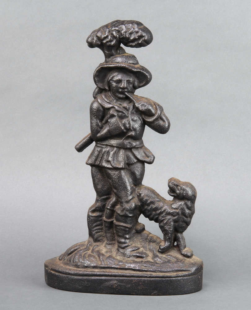 A Victorian cast iron doorstop in the form of a standing gentleman with dog 35cm h x 22cm w x 7cm d