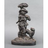 A Victorian cast iron doorstop in the form of a standing gentleman with dog 35cm h x 22cm w x 7cm d
