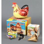 A Chinese M610 tinplate battery operated hen laying eggs boxed, a Chad Valley clock money box boxed,