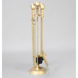 A contemporary Victorian style brass 4 piece fireside companion set comprising shovel, tongs,