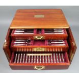A mahogany 2 door canteen containing a set of silver handled lily pattern cutlery comprising 18