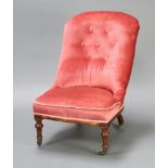 A Victorian nursing chair upholstered in rose pink buttoned Dralon, raised on turned supports 63cm h