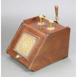 An Edwardian walnut coal box with embossed brass panel to the front complete with shovel and zinc