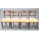 A set of 4 Victorian mahogany spoon back dining chairs with carved mid rail and over stuffed