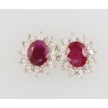 A pair of 9ct yellow gold oval ruby and diamond ear studs, the rubies 3.85ct and diamonds 0.24ct,