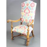 An Italian bleached and carved walnut high back open armchair raised on cup and cover supports