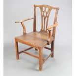 A Georgian Chippendale style country oak carver chair with solid seat raised on square supports with
