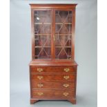 A 19th Century mahogany bookcase on chest, upper section with moulded cornice fitted adjustable