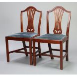 A pair of Hepplewhite style mahogany camel back dining chairs with upholstered drop in seats