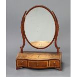A Georgian mahogany oval plate dressing table mirror with swing frame, the base of serpentine