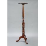 A William IV turned and reeded mahogany bedpost torchere with dish top, raised on tripod supports