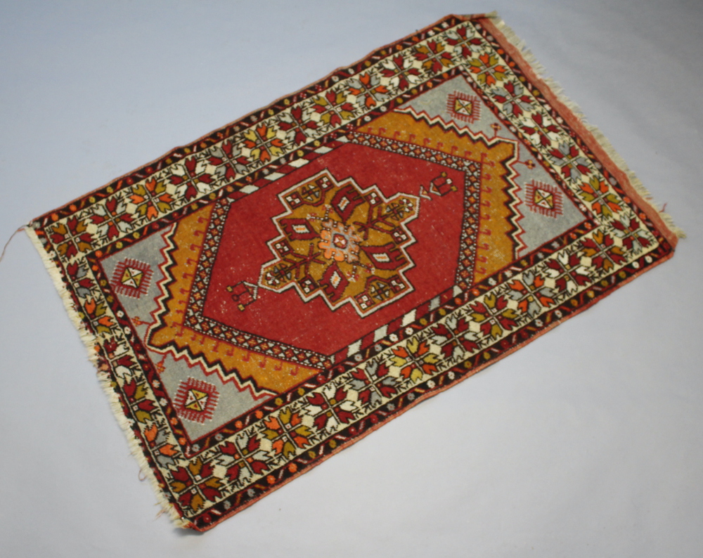 A red, orange and brown ground Afghan rug with central medallion within multi row border 160cm x