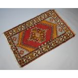 A red, orange and brown ground Afghan rug with central medallion within multi row border 160cm x
