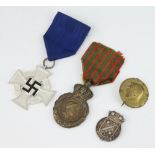 A French medal St Helena, a Third Reich Faithful Service medal, a Minesweeper badge and a pin