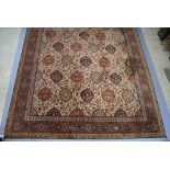 A Persian style machine made carpet with numerous ovals within a floral pattern 642cm x 324cm