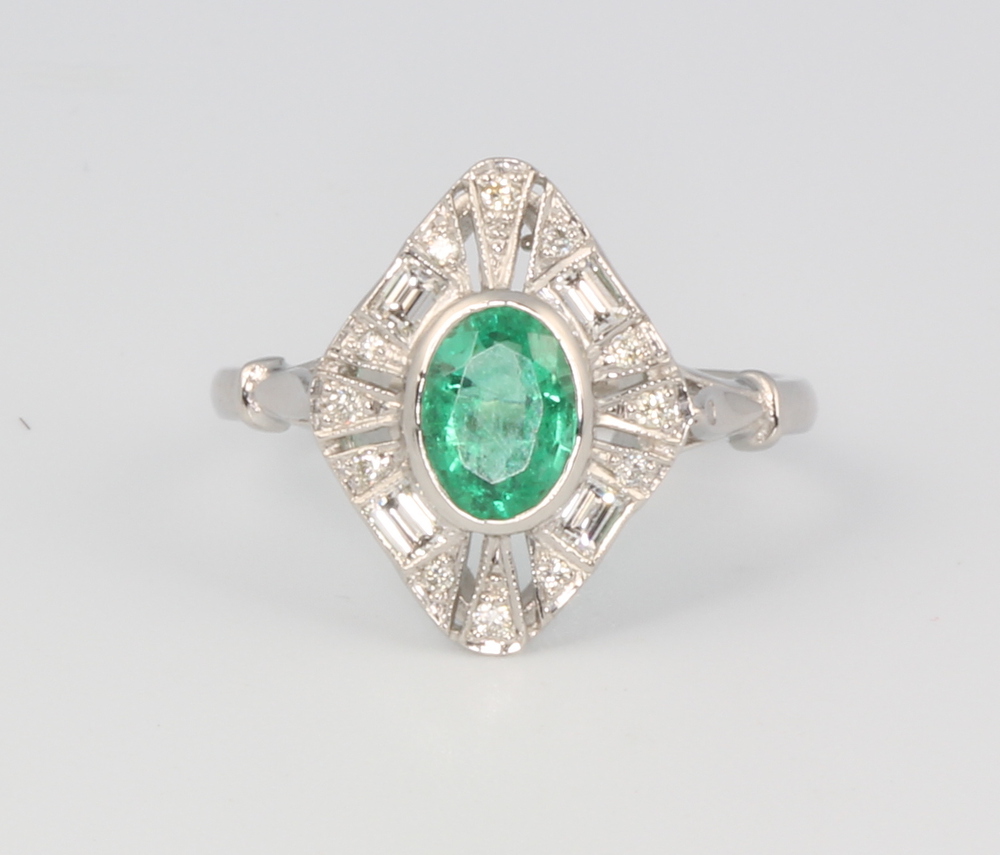 A platinum oval emerald and diamond cluster ring, 4.3 grams, size O, the centre stone approx. 0.