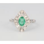 A platinum oval emerald and diamond cluster ring, 4.3 grams, size O, the centre stone approx. 0.