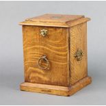 A Victorian square oak smokers cabinet, the hinged lid revealing a fitted compartment with drawer