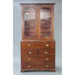 A Georgian mahogany secretaire bookcase with moulded and dentil cornice, fitted adjustable shelves