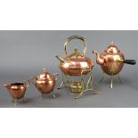 An Art Nouveau copper and brass tea kettle and burner 29cm h x 18cm w x 14cm d together with a