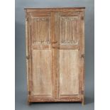 A 1930's Heals style limed oak wardrobe enclosed by panelled doors 183cm h x 110cm w x 54cm d,