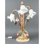 A wrought metal and glass table lamp in the form of an arrangement of lilies 54cm h x 23cm One glass