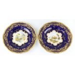 A pair of Coalport decorative plates, the blue and gilt rims enclosing views of "Lagra Charta,