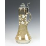 A Continental lustre claret jug with painted white floral decoration and pewter mounts 40cm