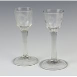 A pair of Georgian clear glass cordials with engraved floral decoration, 14cm