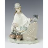 A Lladro group of a reclining lady with baby and water carrier 22cm