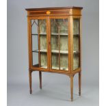 An Edwardian inlaid mahogany display cabinet with moulded cornice, fitted shelves enclosed by