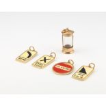 Four enamelled 9ct gold charms and a glass mounted ditto, gross weight 7.4 grams