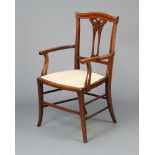 An Edwardian inlaid mahogany open armchair with pierced vase shaped slat back, upholstered seat,